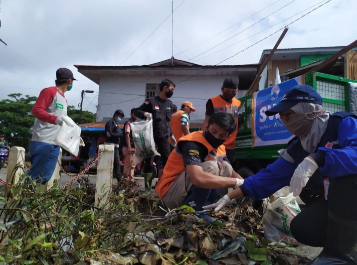 PMI Melawi bersama petugas kebersihan saat membersihkan lingkungan pasar. (Ist) 