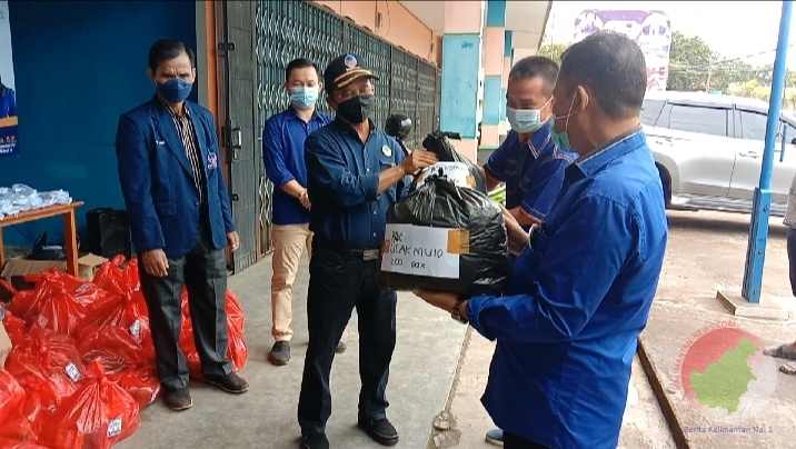 Ketua DPD NasDem Melawi saat menyerahkan bantuan kepada keluarga pasien yang melakukan Isoman. (Dedi Irawan) 